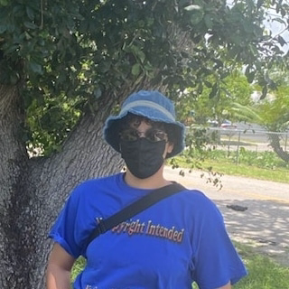 Portrait image of a lightskinned brown person a shirt that reads: copyright intended.